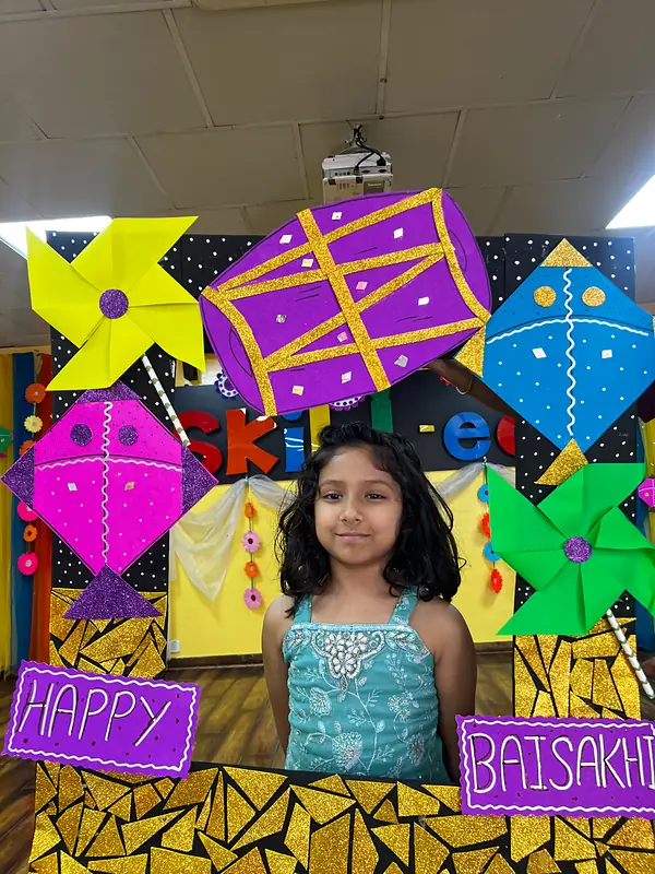 A girl in a turquoise dress smiles from the Happy Baisakhi photo frame