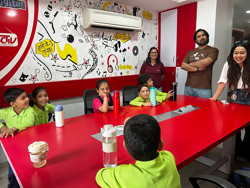 Students laughing with the radio jockeys at RED FM 93.5