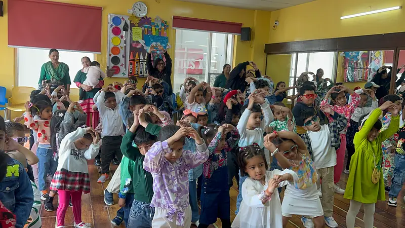 Children dancing together in the activity hall at the welcome party