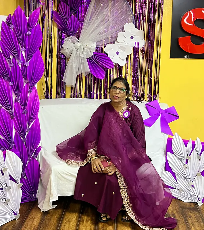 Grandparents at the purple flower booth on Grandparents Day