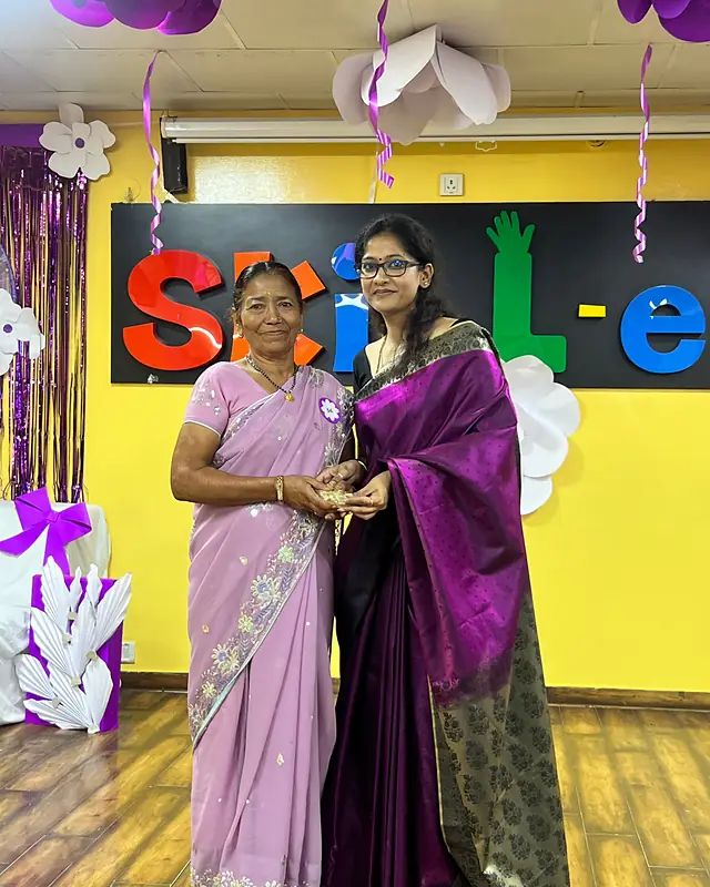 A grandmother receives her trophy on stage