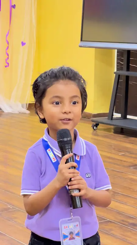 A young student speaks to the grandparents on the microphone